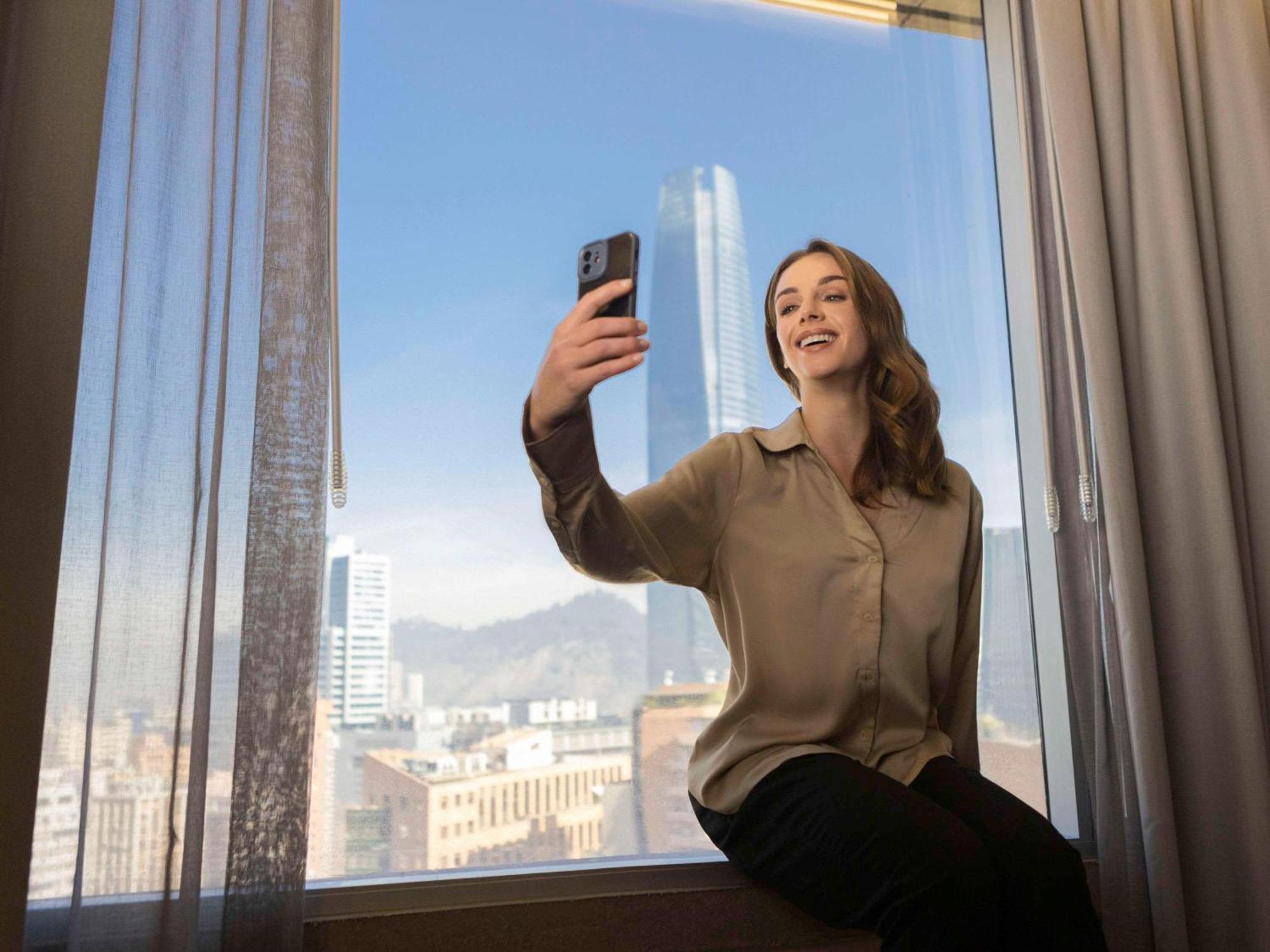 Pullman Santiago El Bosque Hotel Bagian luar foto A woman taking a selfie