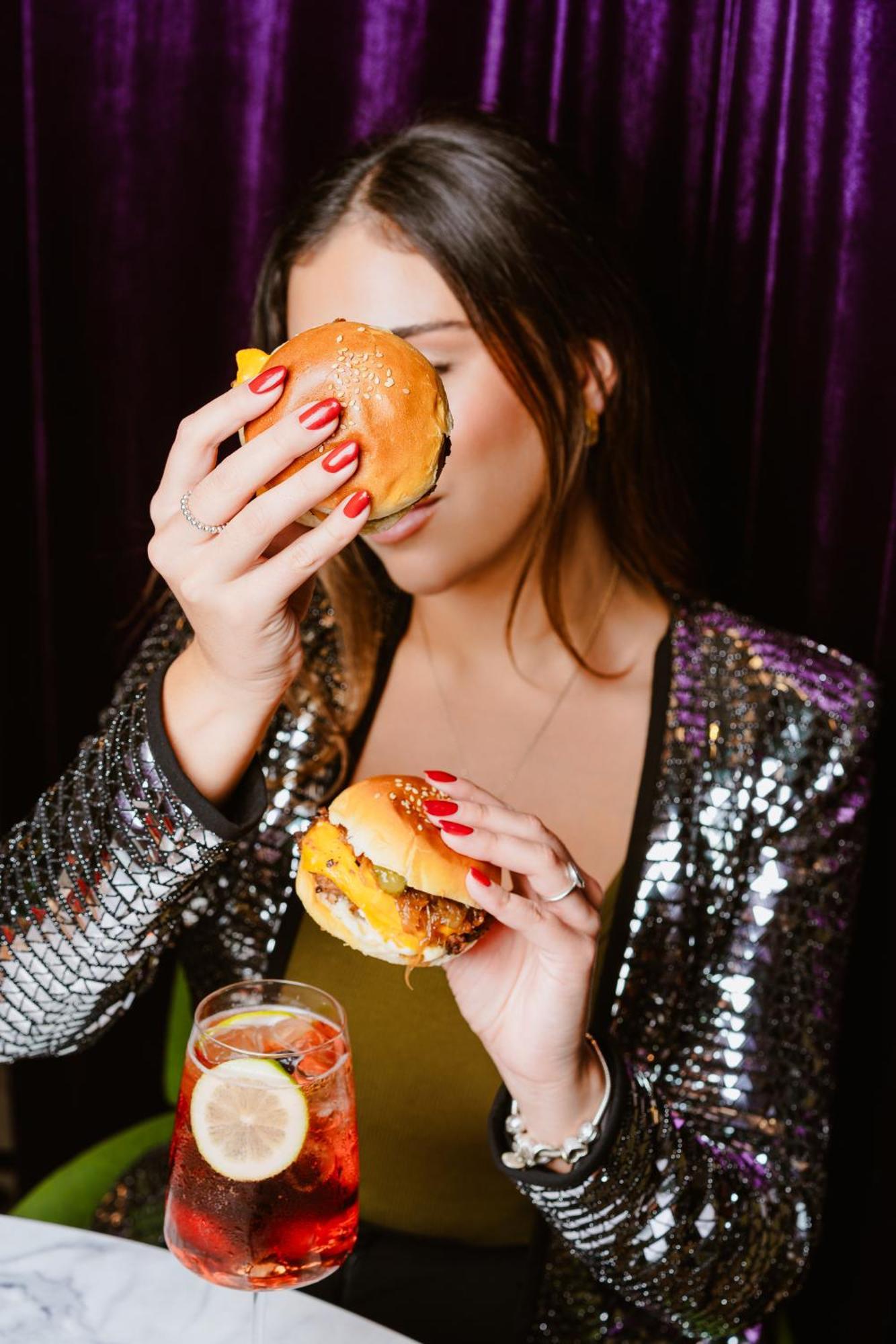 Pullman Santiago El Bosque Hotel Bagian luar foto A woman eating a hamburger